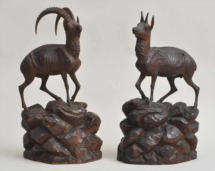 Appraisal: PAIR OF GERMAN CARVED WALNUT IBEXES A male and female