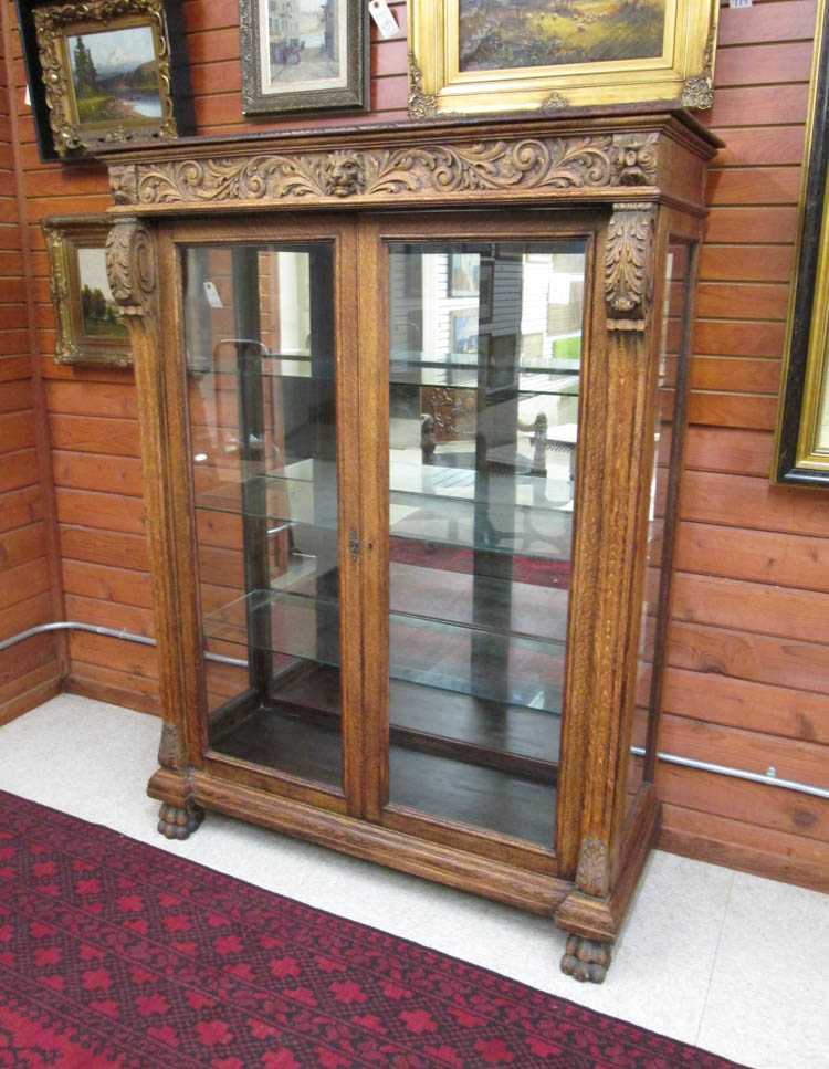 Appraisal: GLASS AND CARVED OAK CHINA DISPLAY CABINET American late th