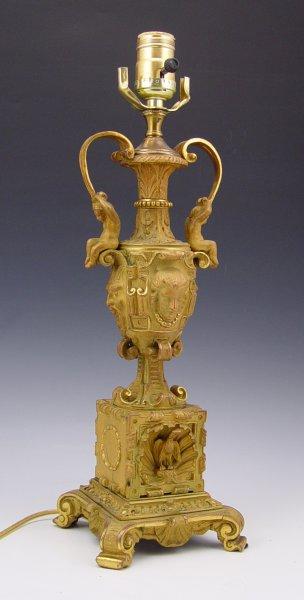 Appraisal: GILT BRONZE LAMP Putti figural handles over masquerons Base is