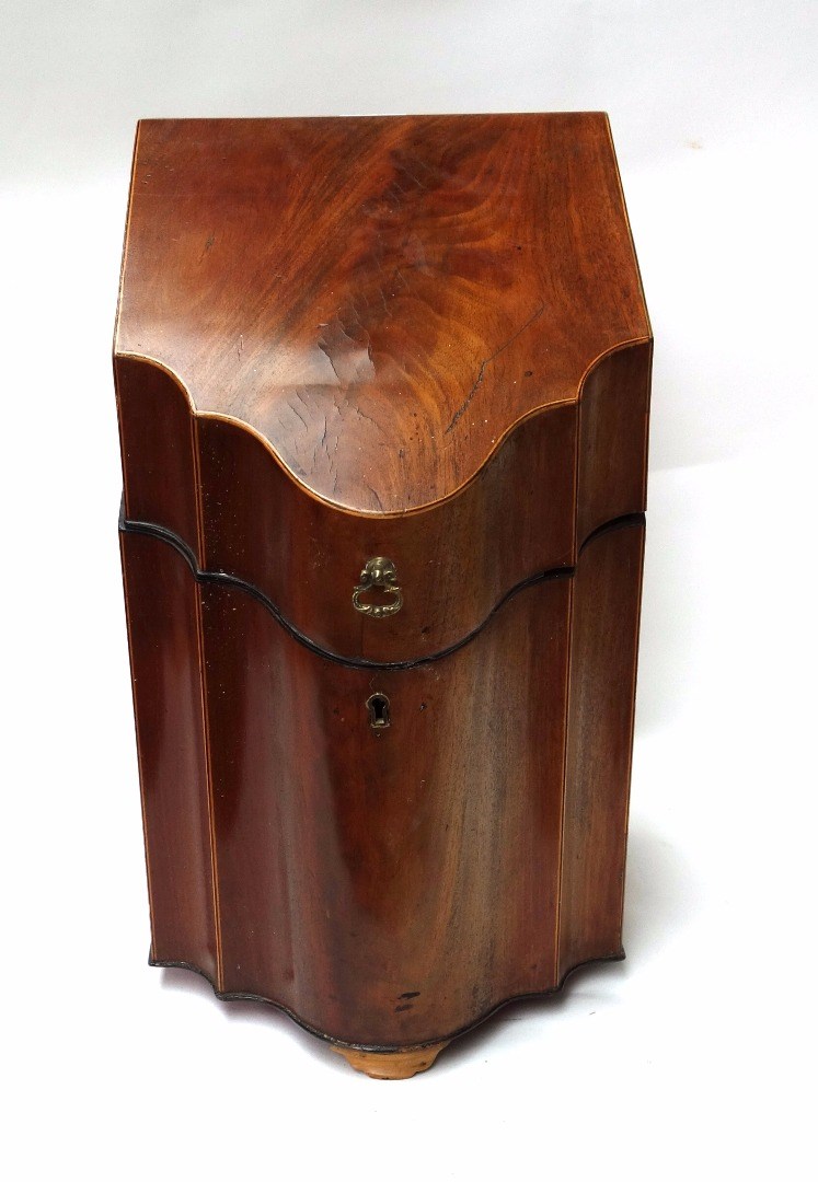 Appraisal: A George III mahogany slope fronted serpentine knife box with