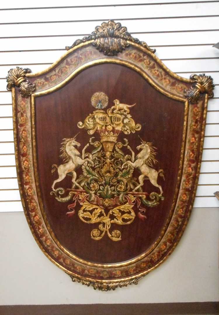 Appraisal: A LARGE SHIELD-SHAPED WALL PLAQUE hand painted coat-of-arms design on