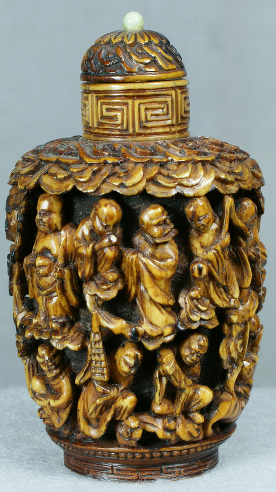 Appraisal: Chinese tea stained ivory snuff bottle with tiny jade bead