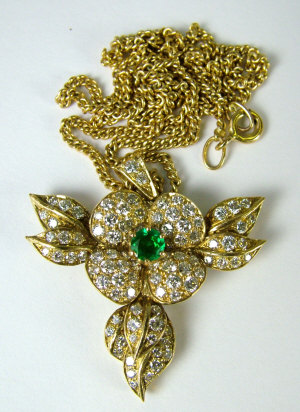 Appraisal: A gold diamond and green garnet pendant In the form