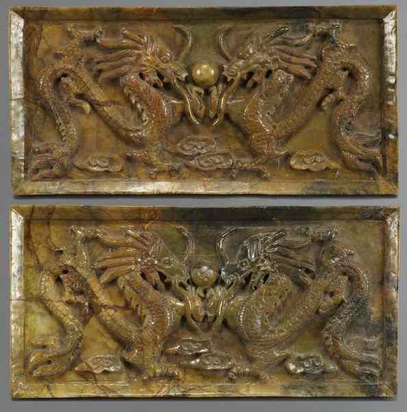 Appraisal: Pr Chinese carved hard stone plaquesdepicting two dragons chasing the