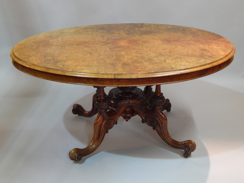 Appraisal: A Victorian burr walnut oval breakfast table the top with