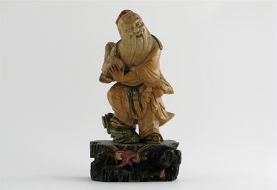 Appraisal: A Chinese soapstone carving of Shoulao standing holding the peach