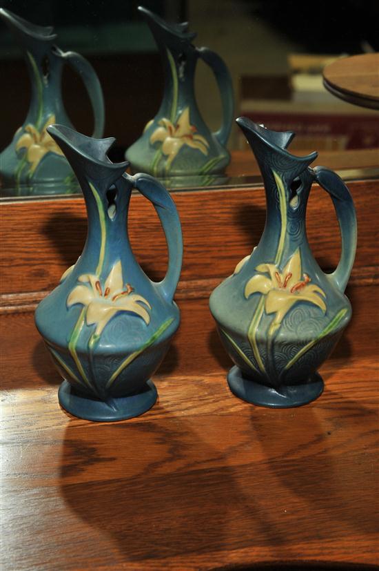 Appraisal: TWO ROSEVILLE POTTERY EWERS Near pair in blue Zephyr Lily