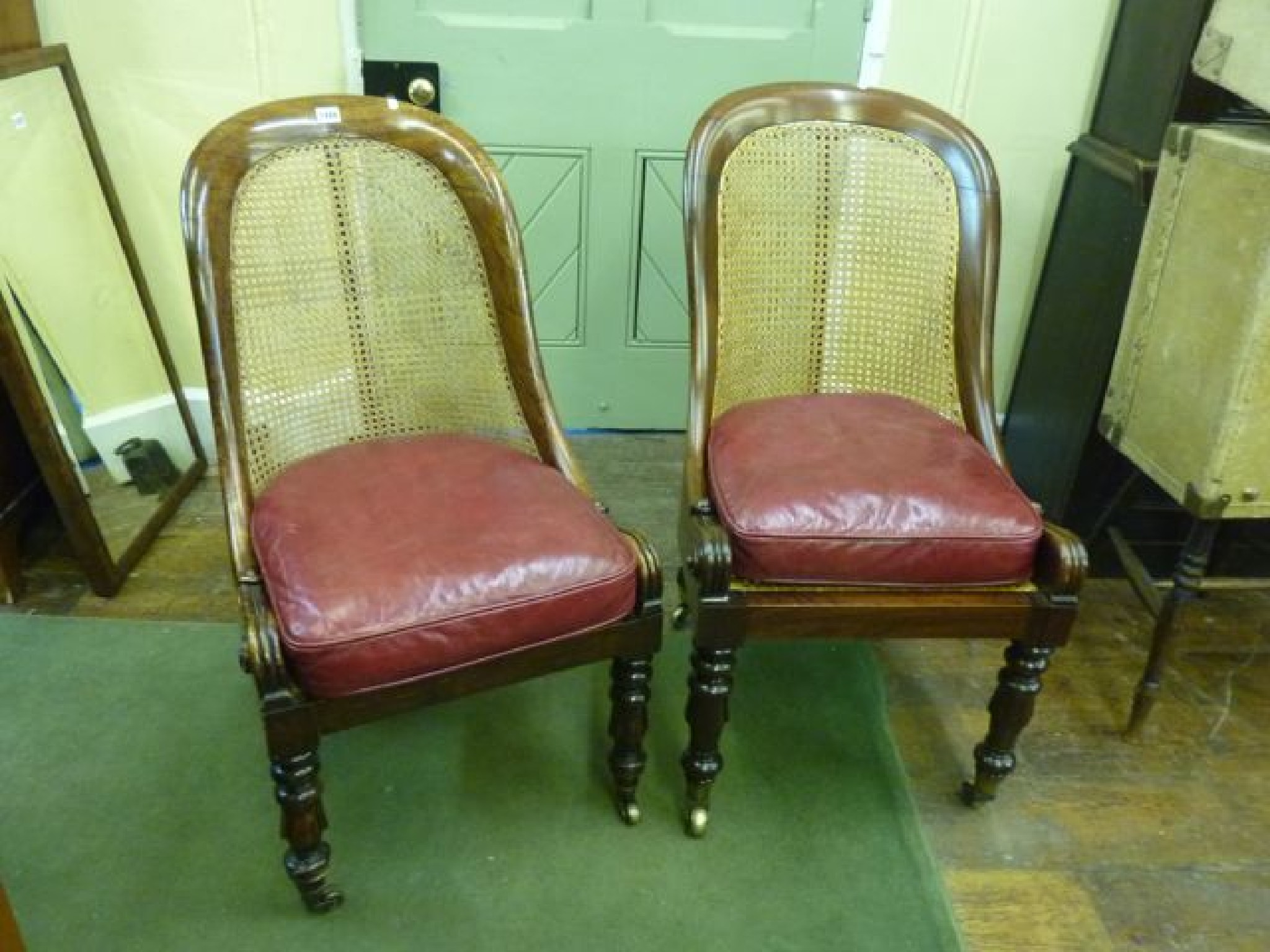 Appraisal: A near matched pair of Regency library chairs with horse