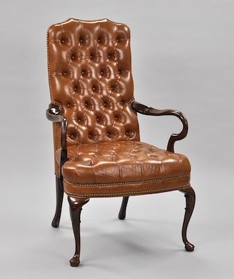 Appraisal: A Leather Upholstered Armchair Deep button tufted brown leather back