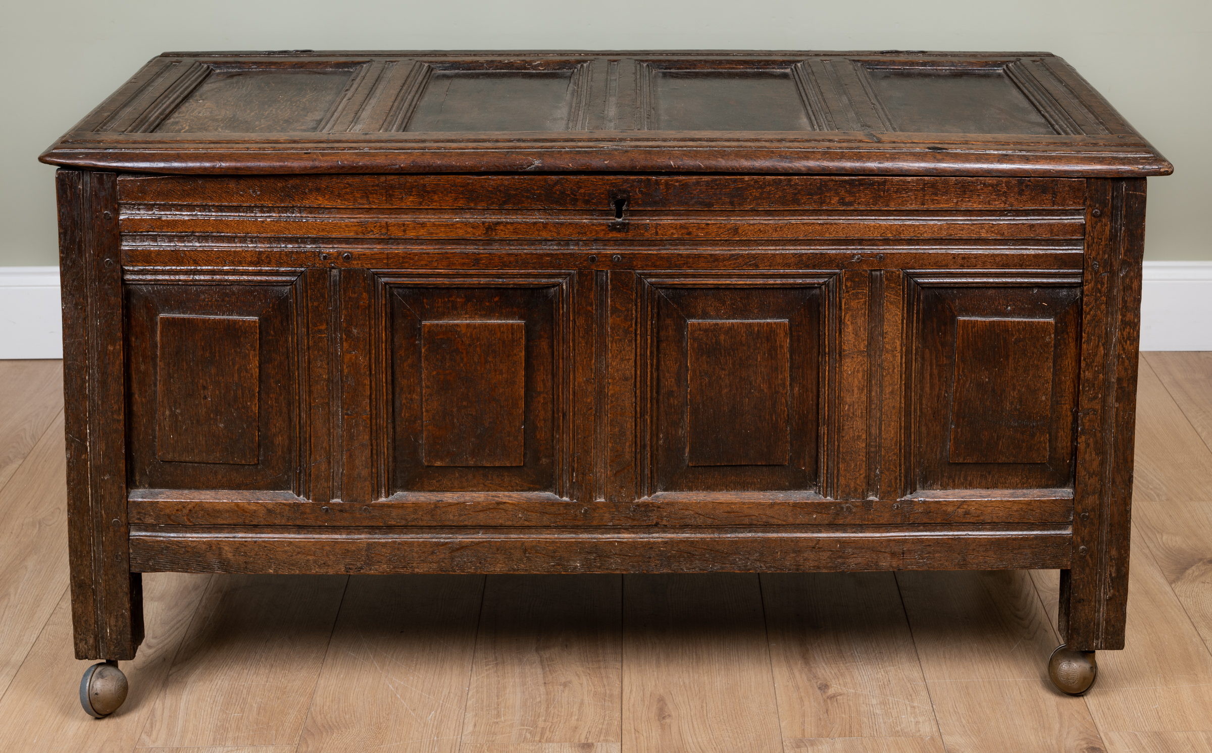 Appraisal: An antique oak panelled chest or coffer with wirework hinges