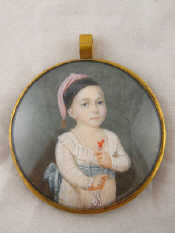 Appraisal: A circular miniature of a young child holding a coral