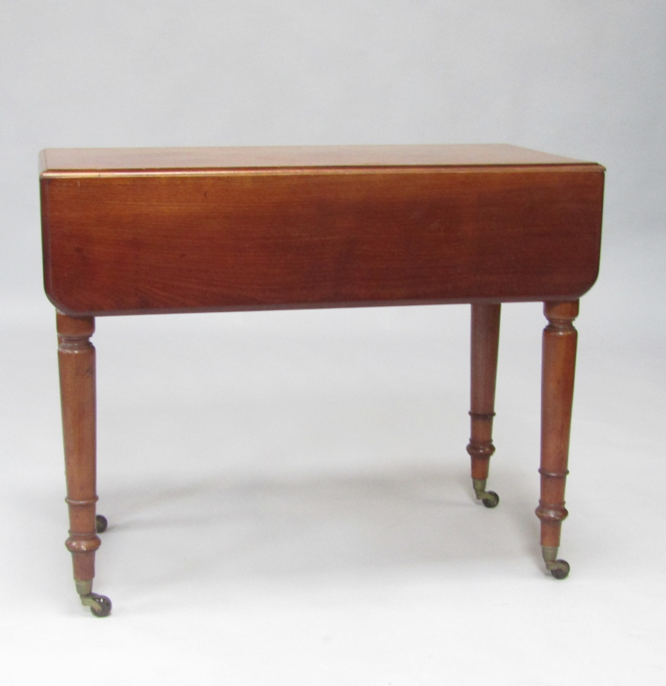 Appraisal: A Victorian mahogany Pembroke table with cushion drawer raised on