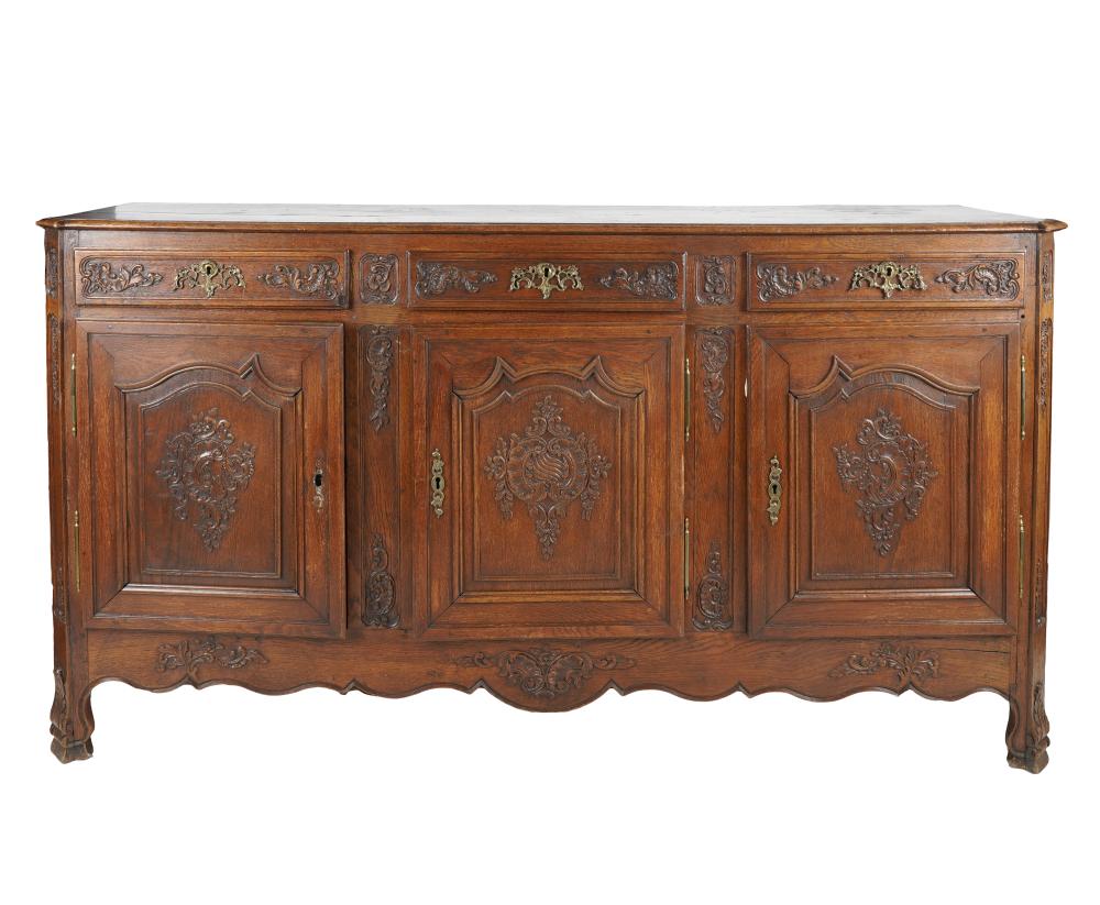 Appraisal: FRENCH PROVINCIAL STYLE CARVED OAK SIDEBOARDhaving three drawers above three