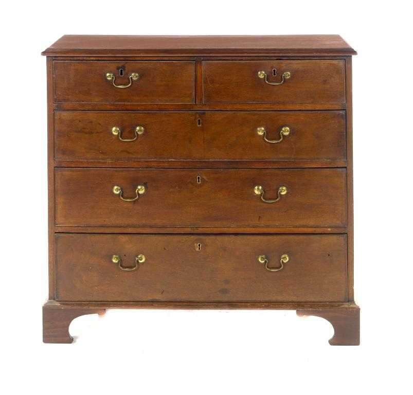 Appraisal: A GEORGE III MAHOGANY CHEST OF DRAWERS fitted two short