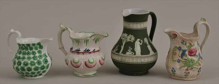 Appraisal: THREE STAFFORDSHIRE IRONSTONE MILK JUGS Each baluster-form body with relief-molded