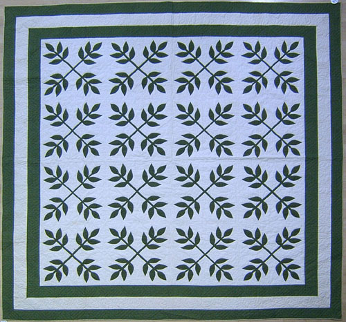 Appraisal: Green calico appliqu quilt ca in a leaf pattern with