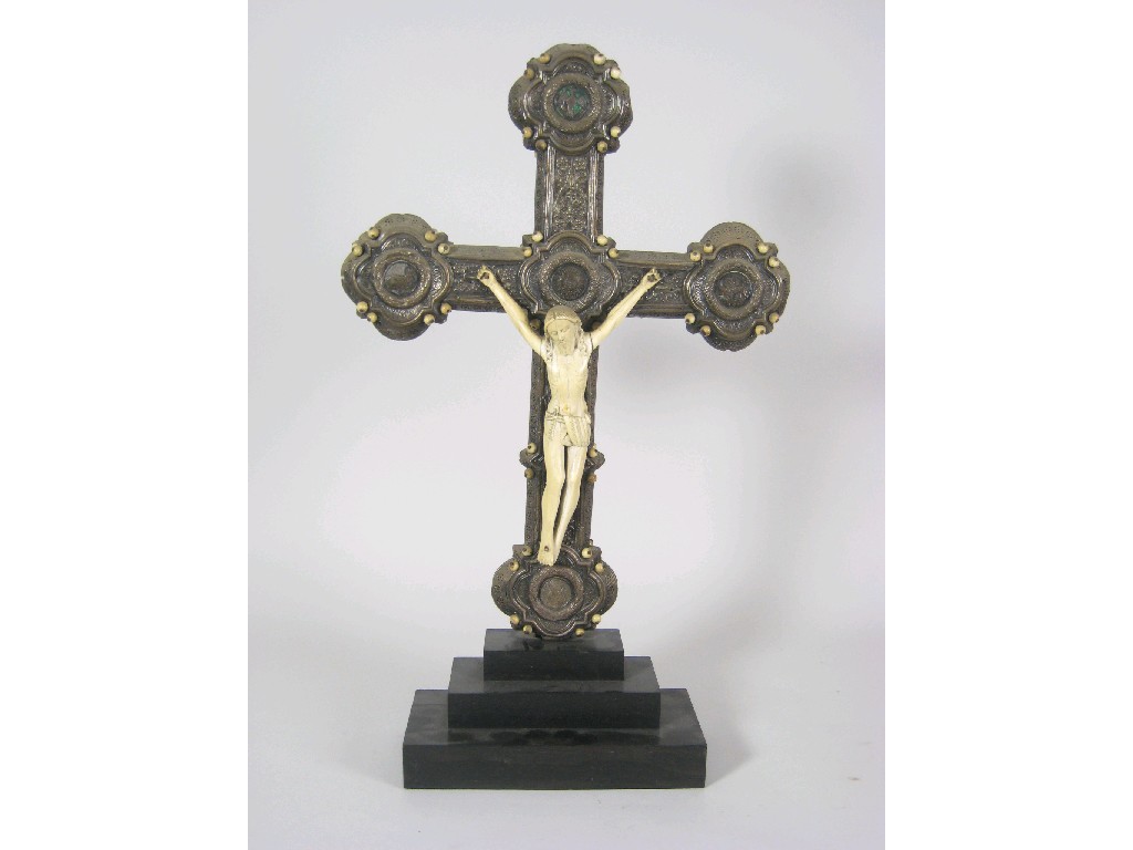 Appraisal: A continental Crucifix in white metal with embossed floral and