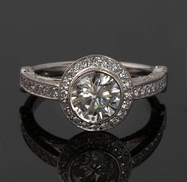 Appraisal: A diamond ring centering a round brilliant-cut diamond weighing an