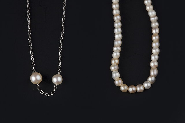 Appraisal: A SINGLE STRAND PEARL NECKLACE WITH DIAMOND SET CLASP the