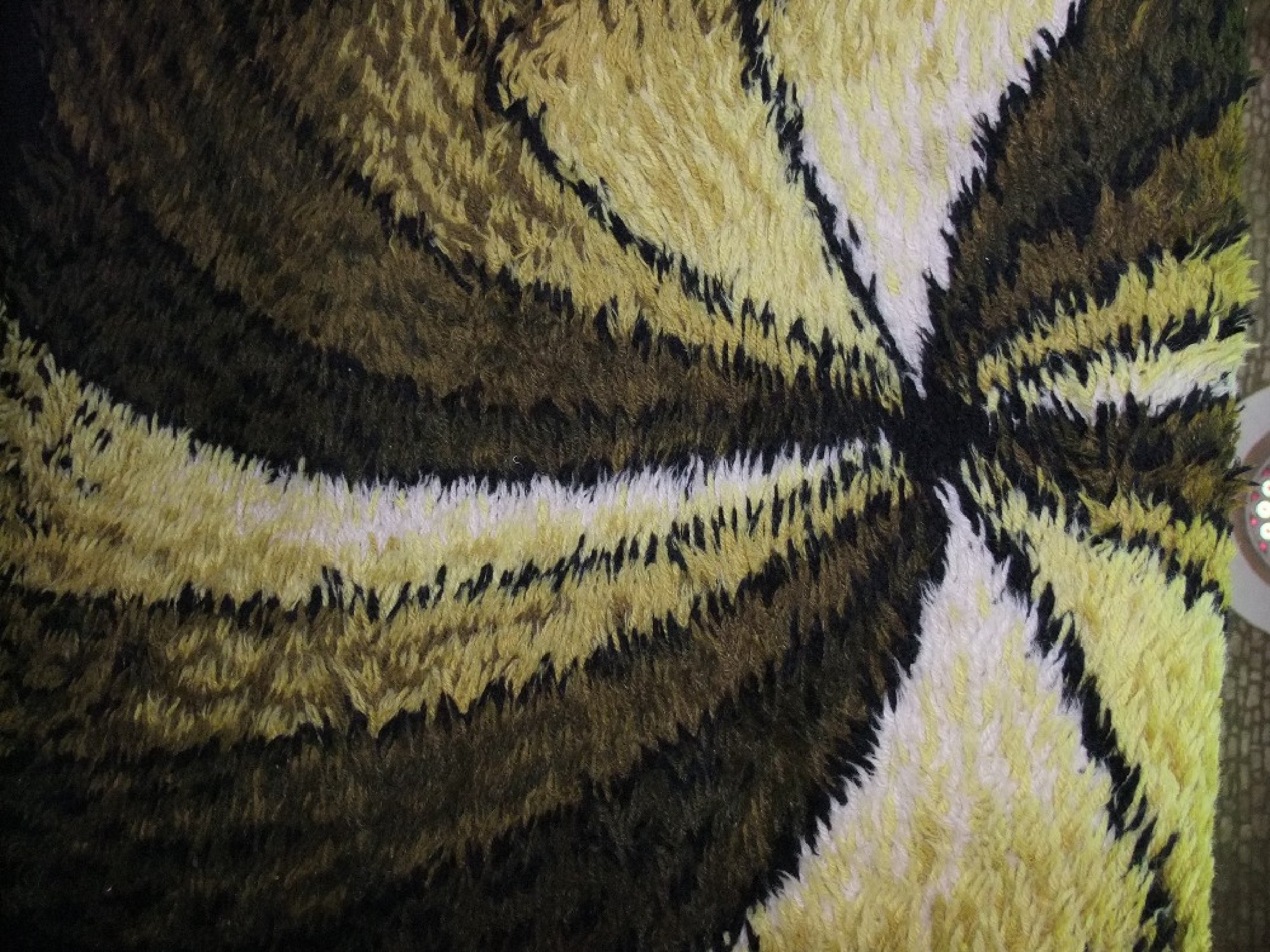 Appraisal: A deep pile wool rug with abstract spin design detail