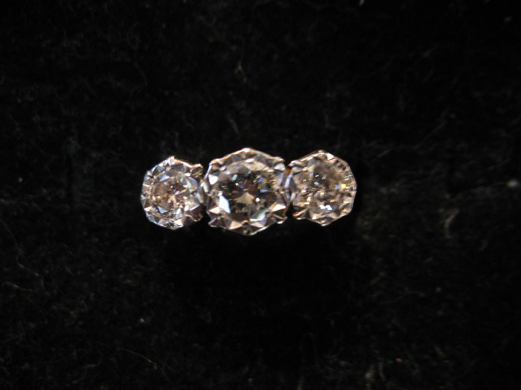 Appraisal: A THREE STONE DIAMOND RING the three graduated diamonds illusion-set