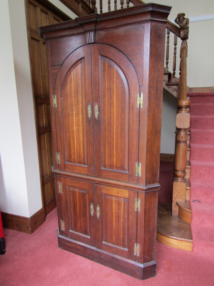 Appraisal: A George III oak standing corner cupboard with Greek key