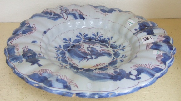 Appraisal: A fluted blue white and manganese dish Delft or Hanau