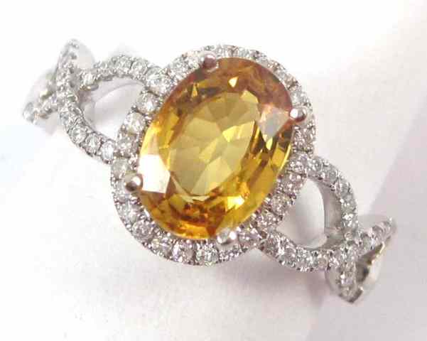 Appraisal: YELLOW SAPPHIRE AND DIAMOND RING k white gold centering an