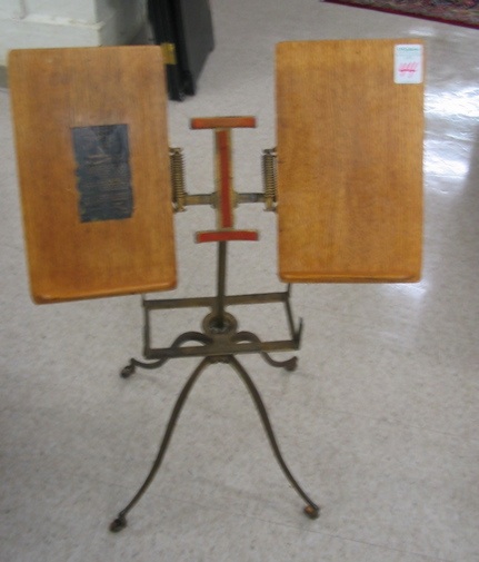 Appraisal: AN OAK AND CAST IRON DICTIONARY STAND La Verne W