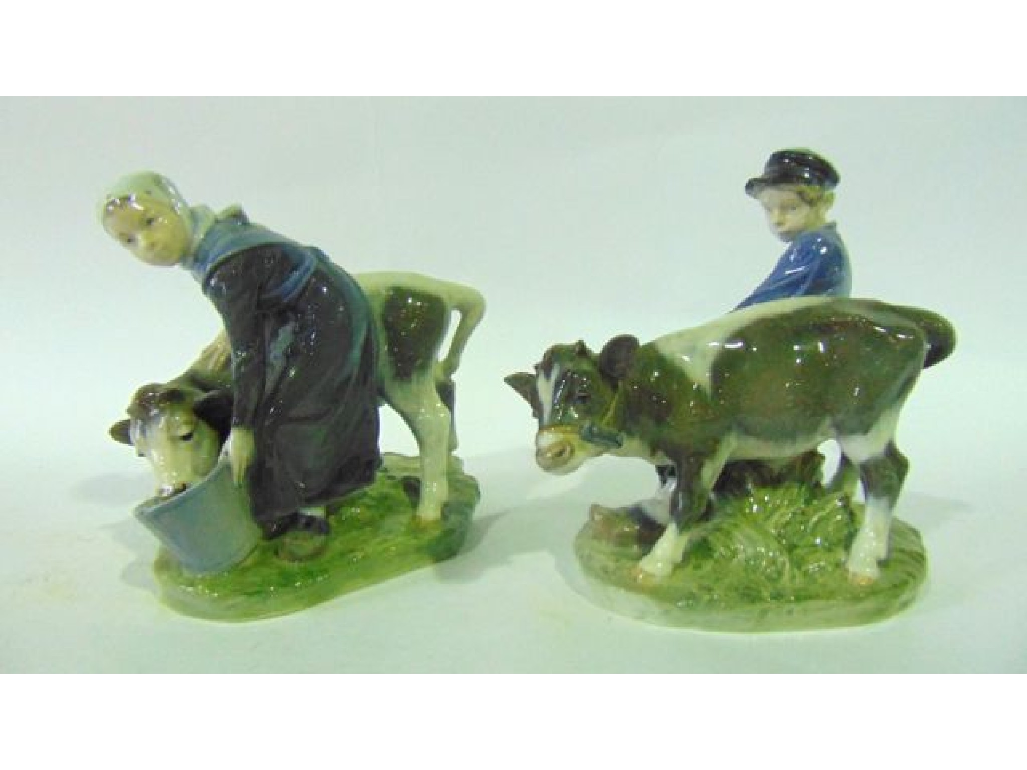 Appraisal: A pair of Royal Copenhagen figures of a young milk