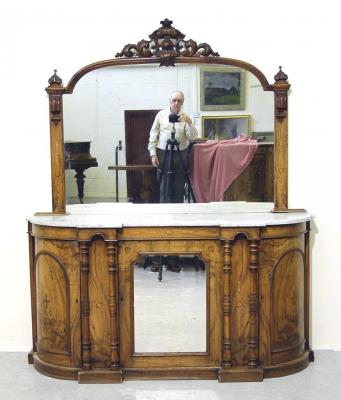 Appraisal: A VICTORIAN CARVED WALNUT CHIFFONIER the shaped mirror back with