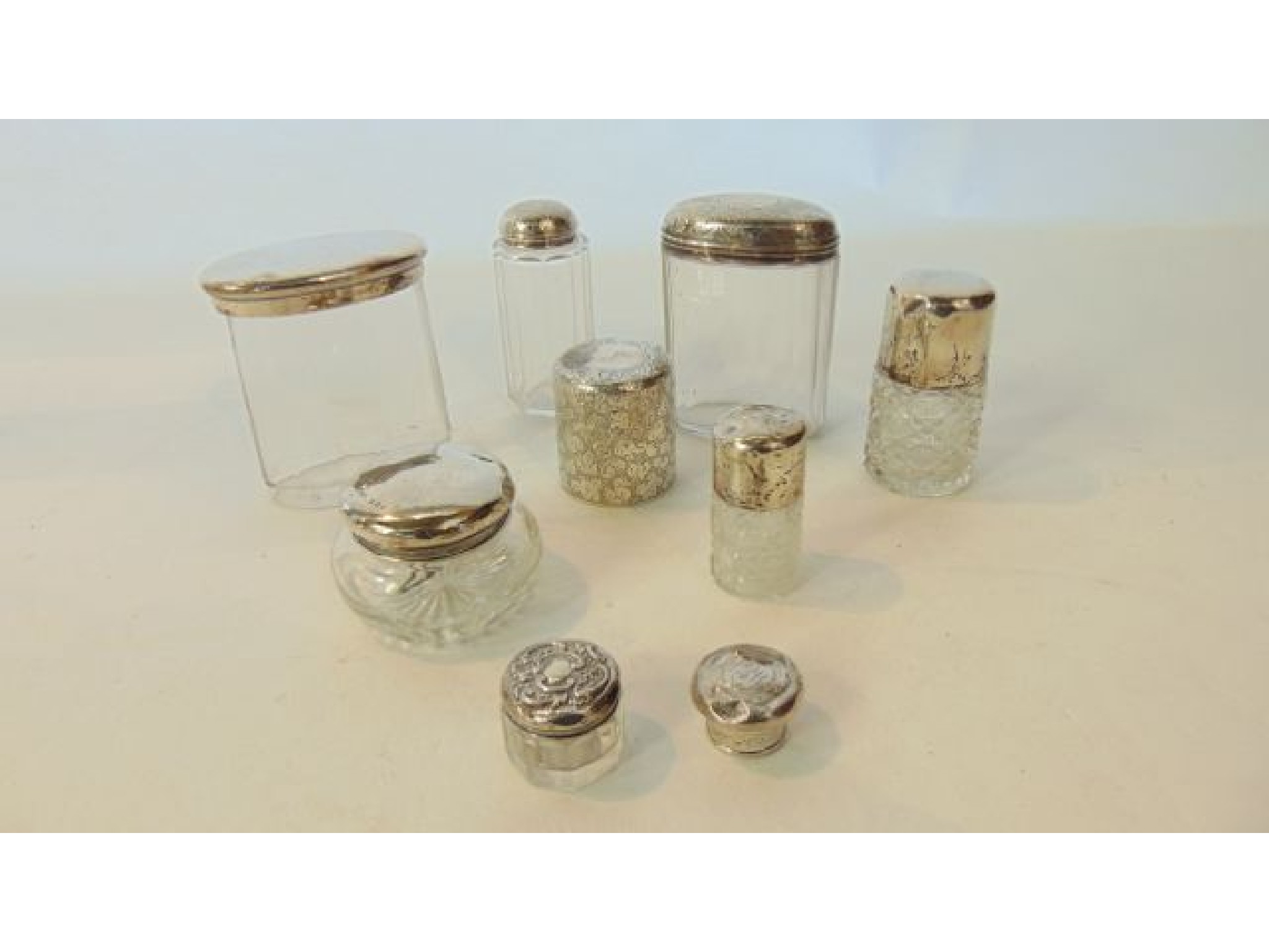 Appraisal: A miscellaneous collection of seven silver-mounted dressing table containers various