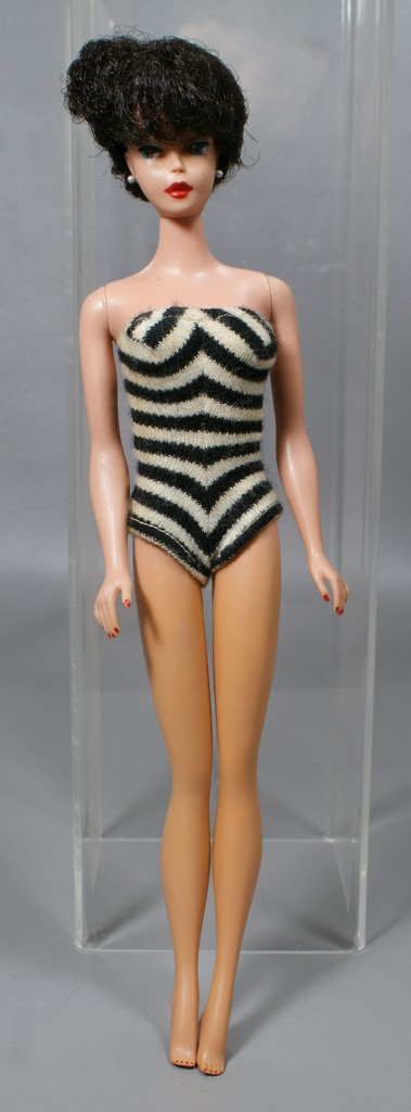 Appraisal: Barbie wearing black and white one piece bathing suit pierced