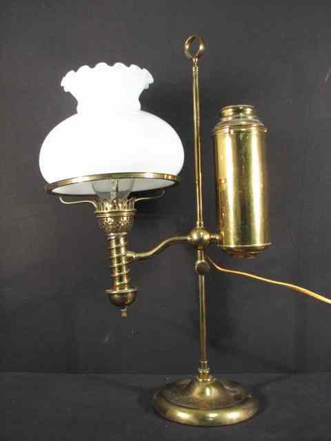 Appraisal: An electrified brass student oil lamp with a white glass