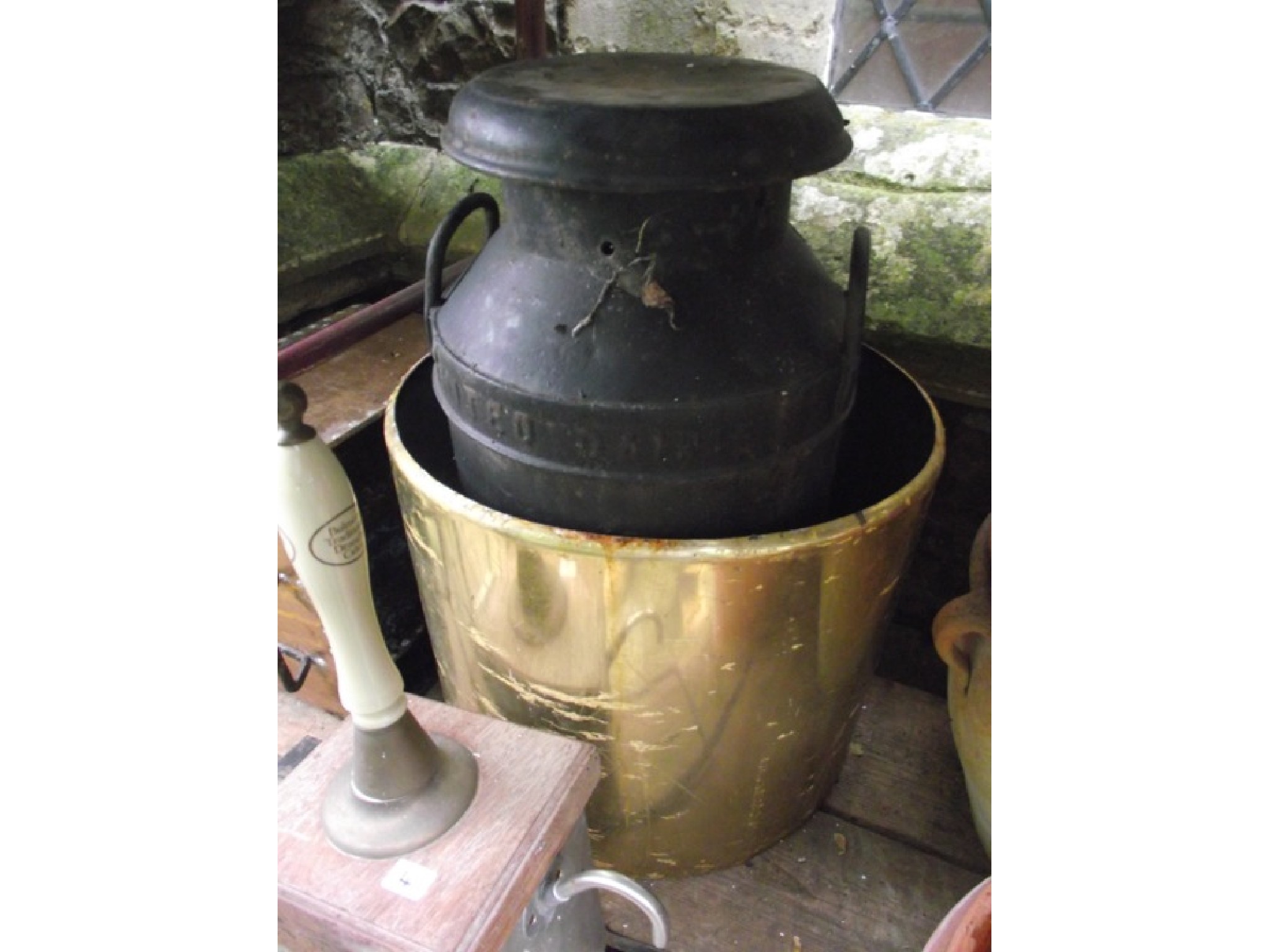 Appraisal: A vintage cast iron milk churn complete with cap with