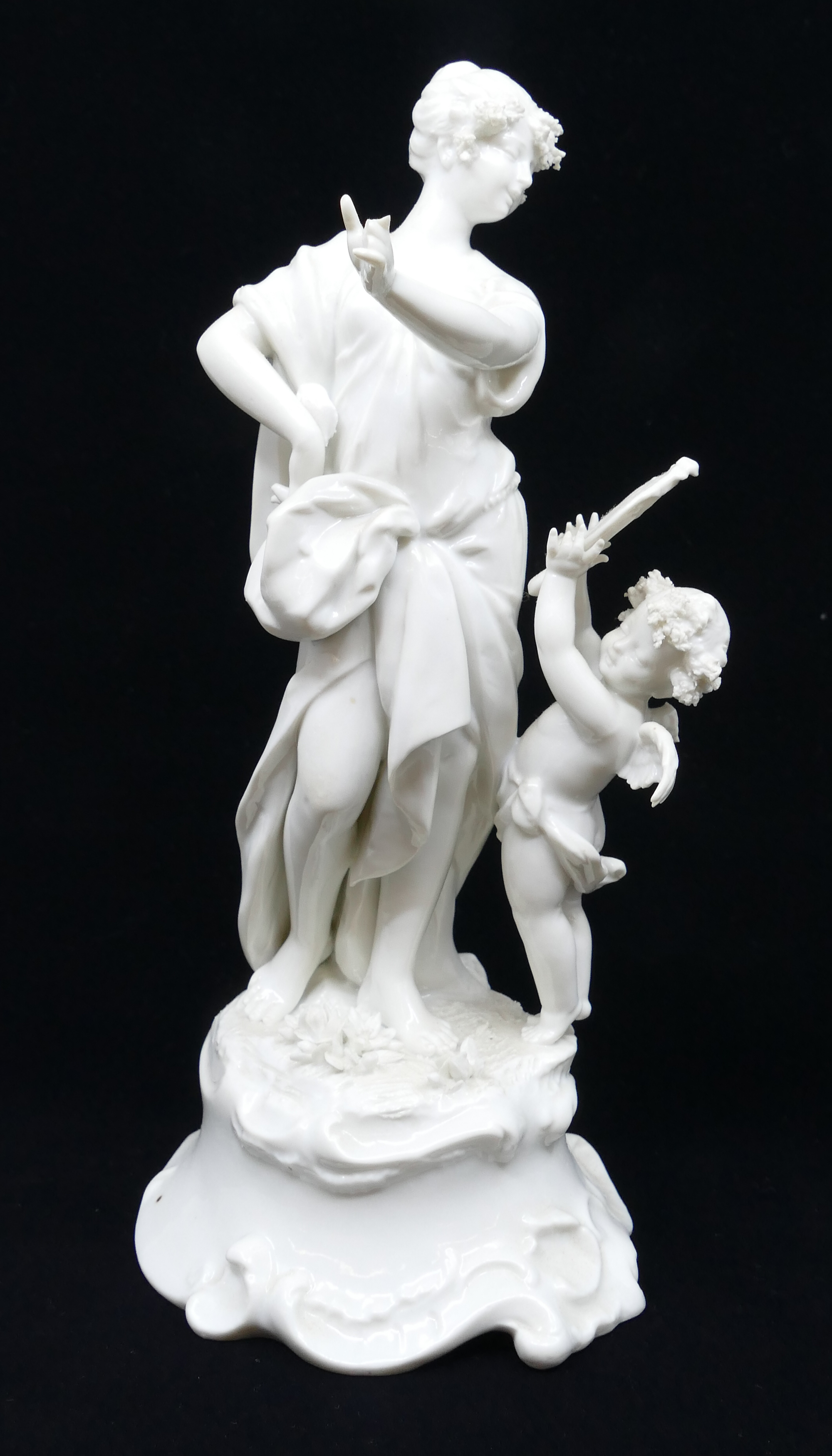 Appraisal: Woman with Cherub Blanc de Chine Porcelain Figure Group Appears