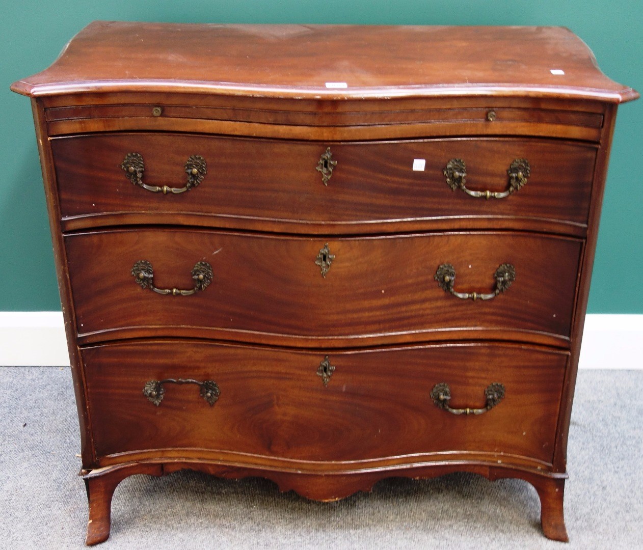 Appraisal: A made-up th century mahogany serpentine chest the brushing slide