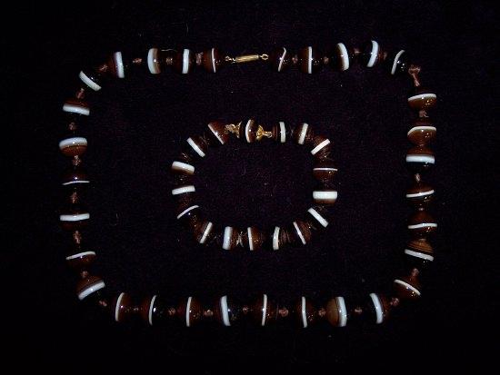 Appraisal: A necklet of agate beads with circular striped stone beads