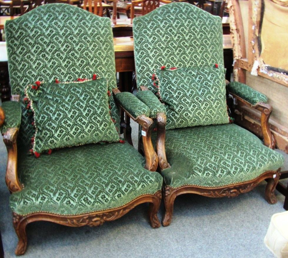 Appraisal: A pair of th century French oak framed open armchairs