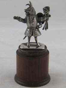 Appraisal: A silver ''Trusty Servant'' figure on turned wood plinth Gross