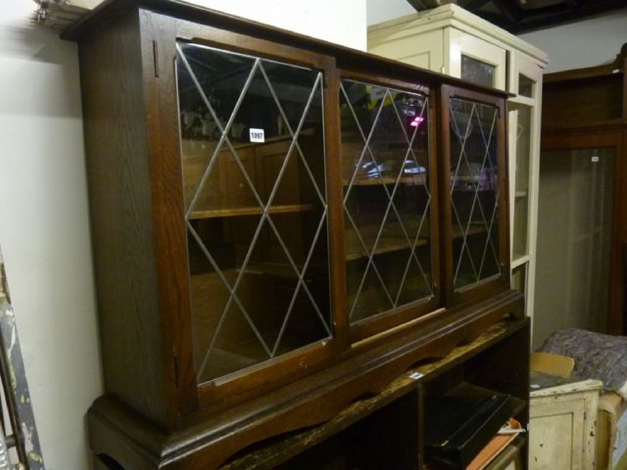 Appraisal: A low and slender freestanding oak bookcase enclosed by three