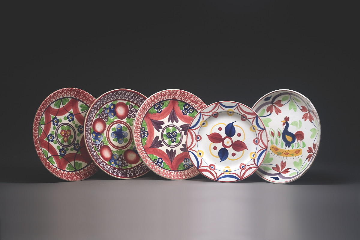 Appraisal: FIVE ENGLISH POTTERY ENAMEL-DECORATED WARES NINETEENTH CENTURY Comprising a platter