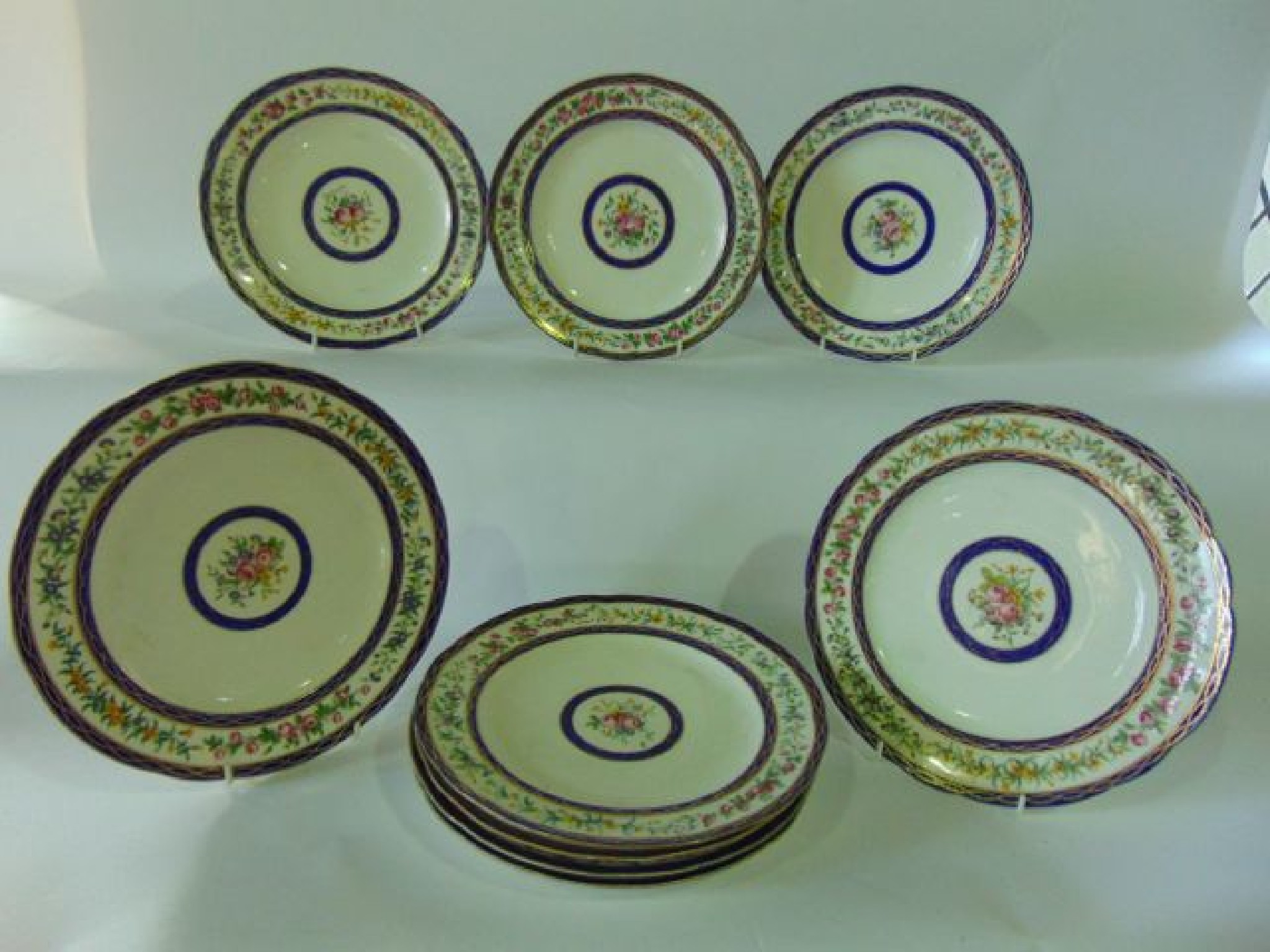 Appraisal: A set of nine continental dessert plates with painted floral