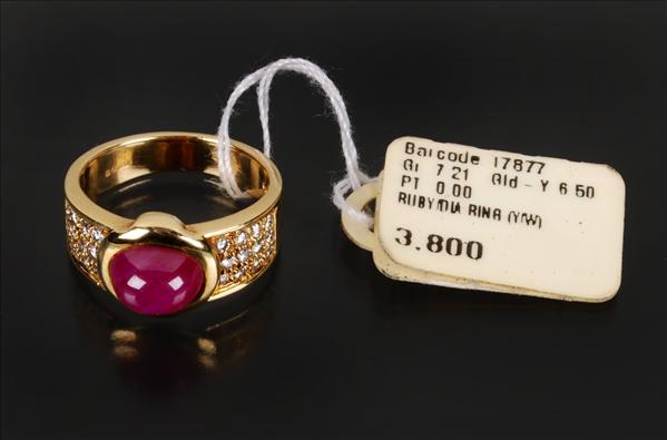 Appraisal: A ruby and diamond band ring centrally set with a