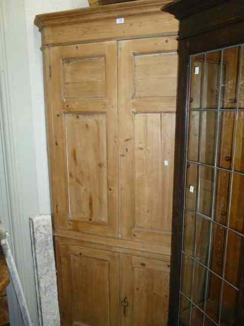 Appraisal: A LARGE PINE FLOOR STANDING CORNER CUPBOARD with four panelled