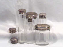 Appraisal: A mixed lot comprising six silver topped toiletry jars one