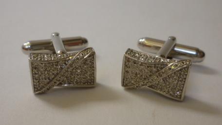 Appraisal: A PAIR OF GOLD AND DIAMOND CUFFLINKS of shaped oblong