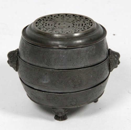 Appraisal: A Chinese pewter three tier censer the pierced circular cover