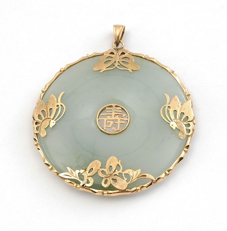 Appraisal: GREEN JADE DONUT WITH KT YELLOW GOLD BUTTERFLY This lovely