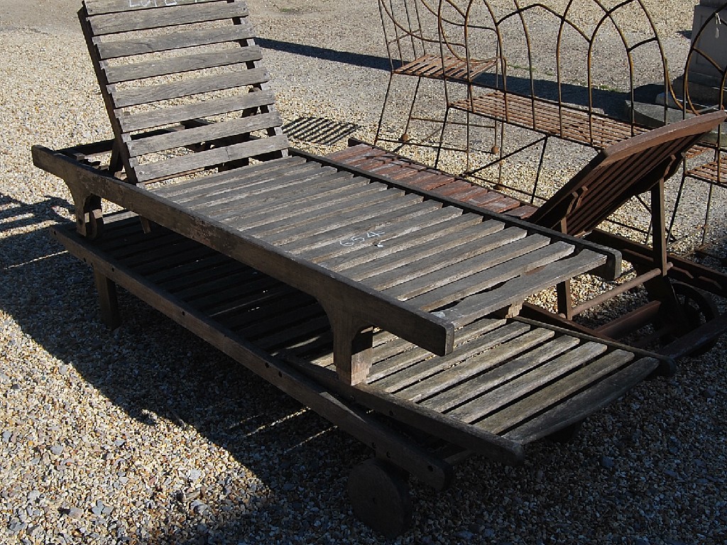 Appraisal: Three teak slatted garden loungers